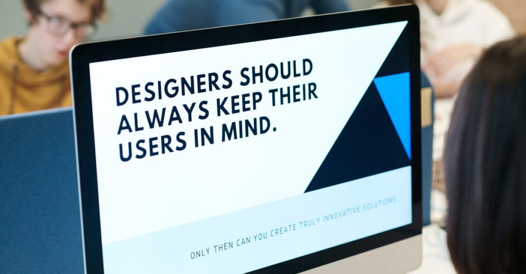 Group of designers collaborating in modern office space with computer.